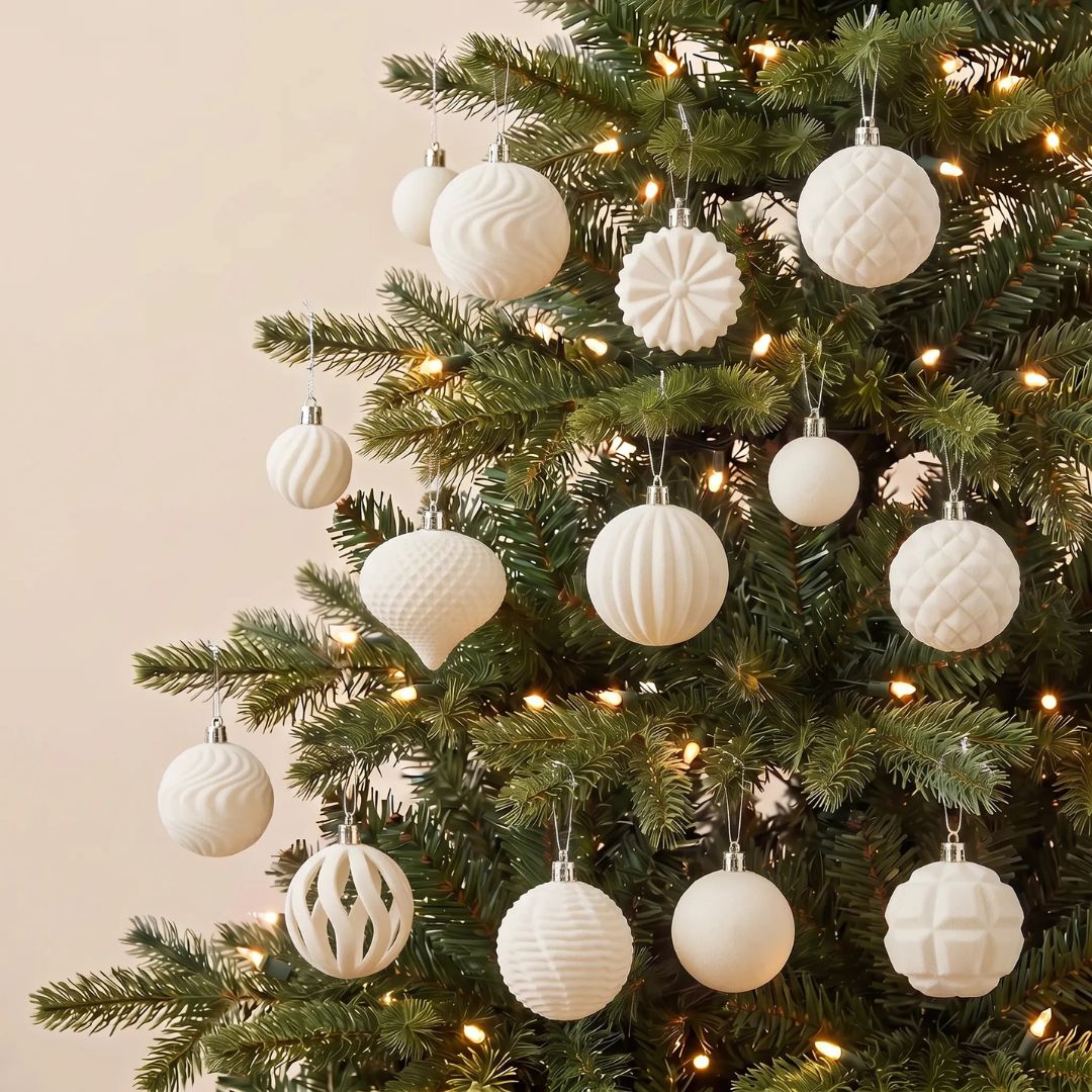 A beautifully styled Christmas tree in a Singapore home decorated with elegant velvet beige baubles and festive ornaments.