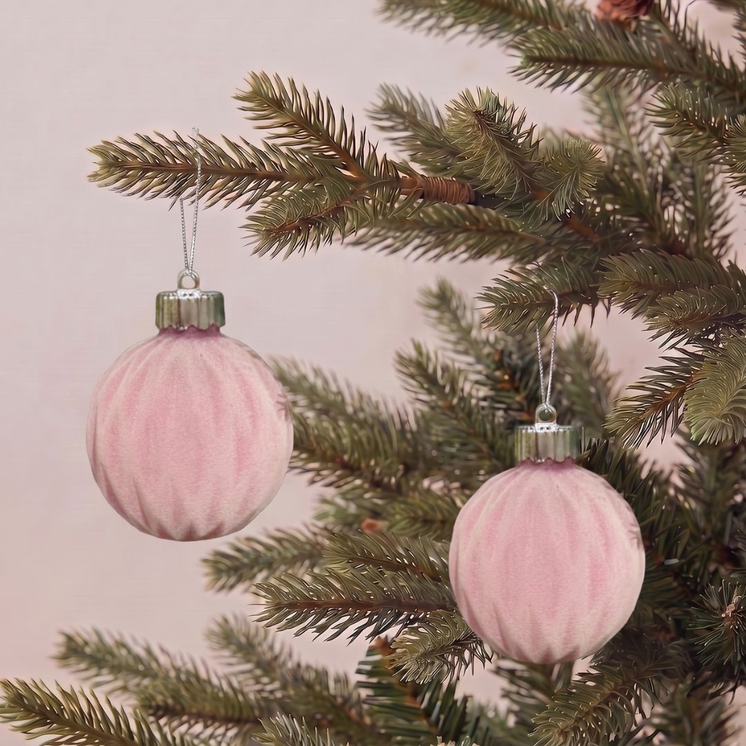 Beautifully decorated artificial Christmas tree featuring blush pink velvet hanging ornaments and premium festive decorations by Speckled Space
