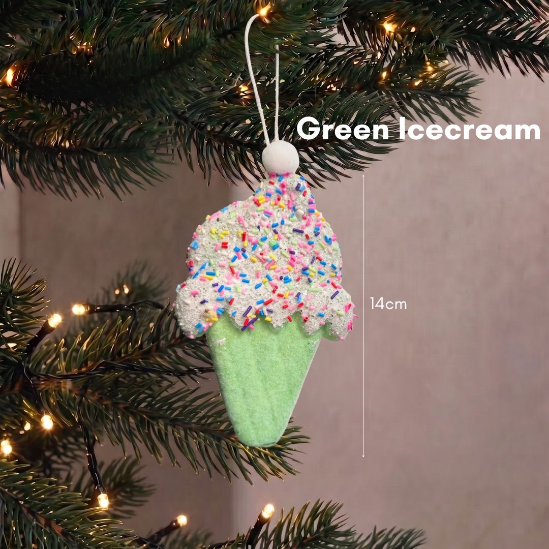 Close-up of a sweet pastel green ice cream cone Christmas tree ornament hanging delicately on dark pine branches.