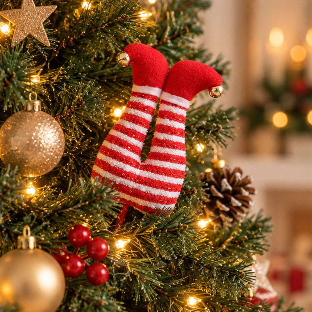 Candy Cane Christmas elf legs tree pick featuring red and white striped legs, red shoes and gold bells nestled in artificial Christmas tree branches.