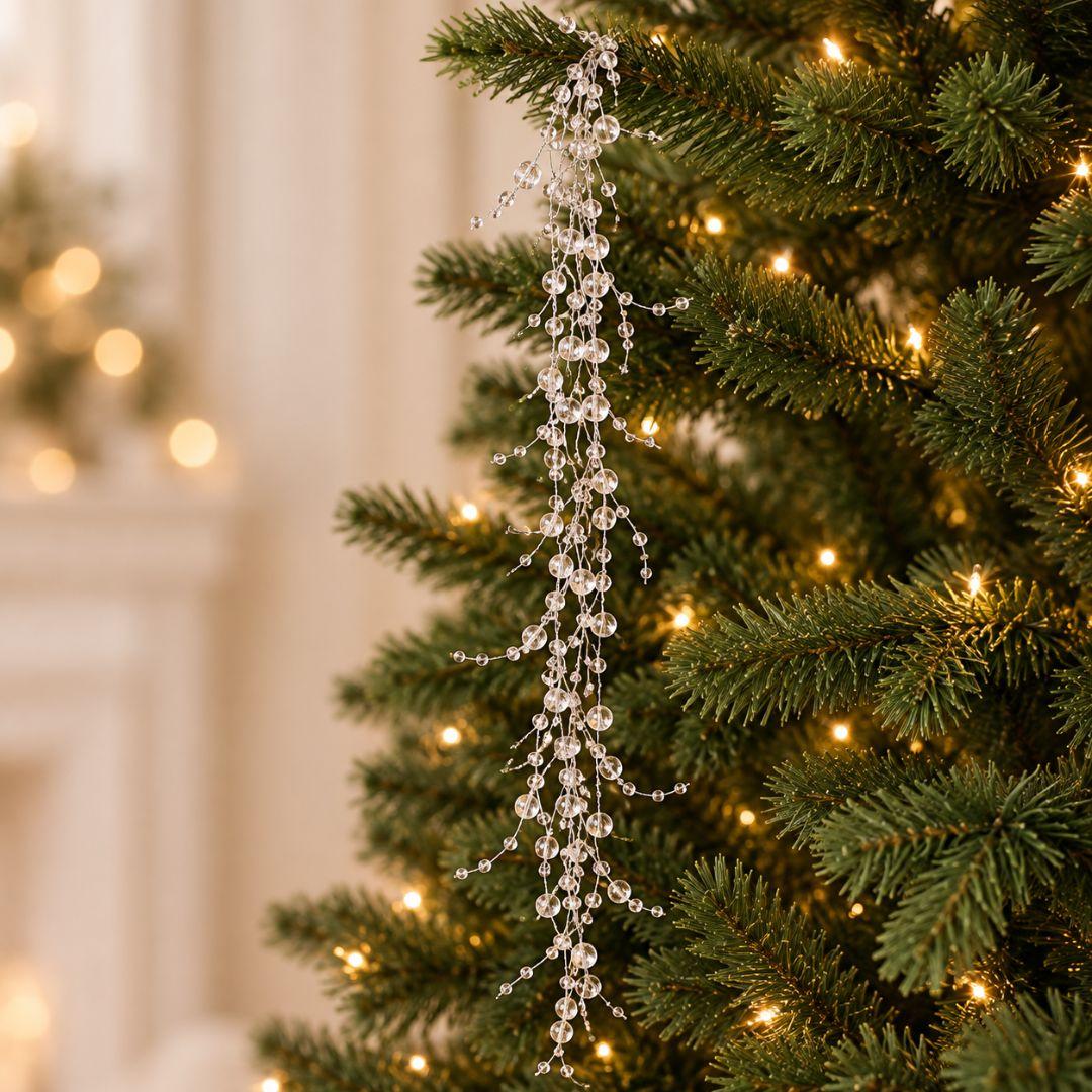 Clear beaded Christmas garland featuring transparent 0.3cm–0.8cm beads cascading from an artificial Christmas tree with warm fairy lights.