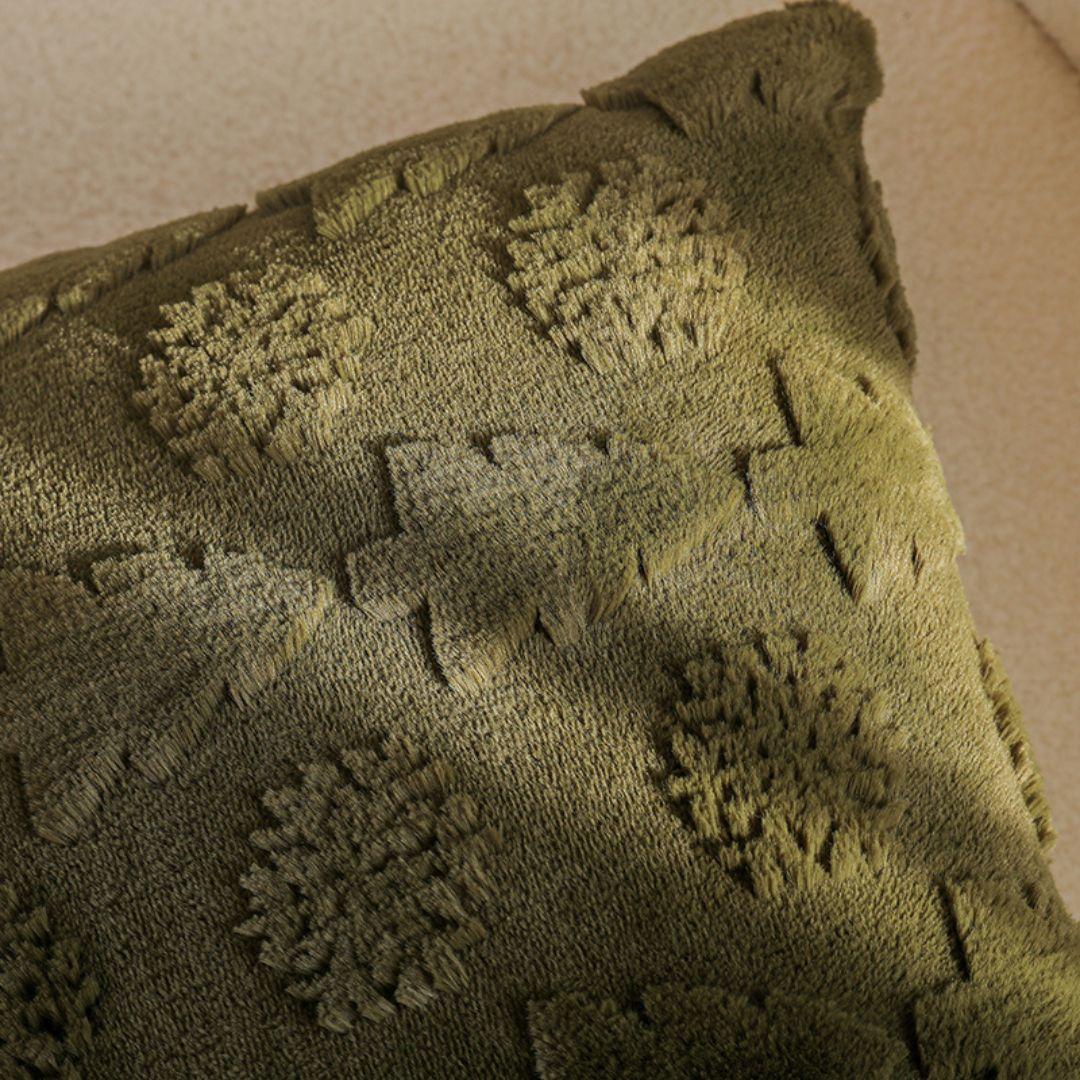 Evergreen Christmas cushion cover in olive green with raised Christmas tree and snowflake patterns.
