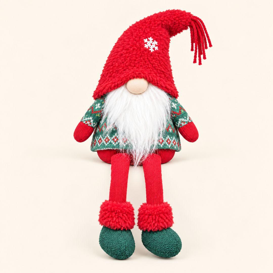 Finn Snowflake Sitting Christmas Gnome with fluffy red hat, white beard, Nordic green outfit and dangling legs on a cream beige background