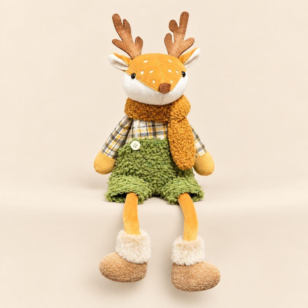 Holly and Hazel sitting Christmas reindeer plush decorations with dangling legs on a wooden table in a festive living room