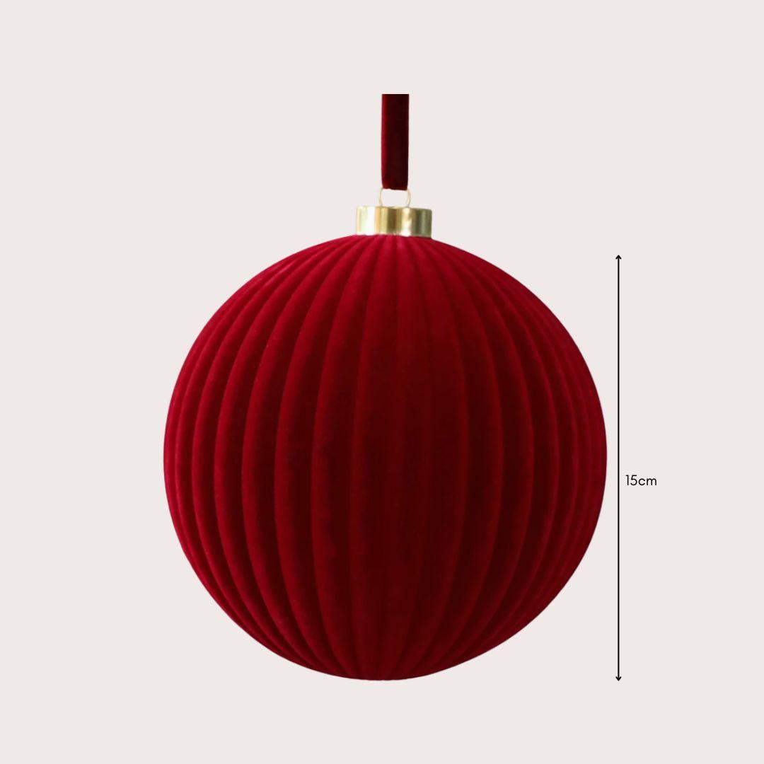 Large 15cm red and ivory velvet Christmas baubles hanging on a warm-lit artificial Christmas tree, featuring smooth and ribbed textures.