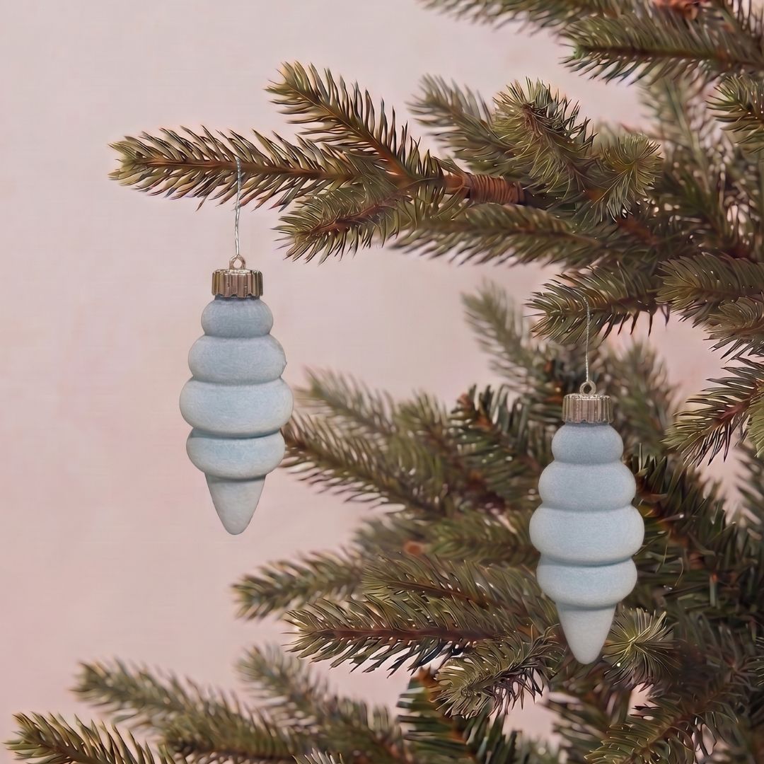 Beautifully decorated artificial Christmas tree featuring light blue velvet hanging ornaments and premium festive decorations by Speckled Space.