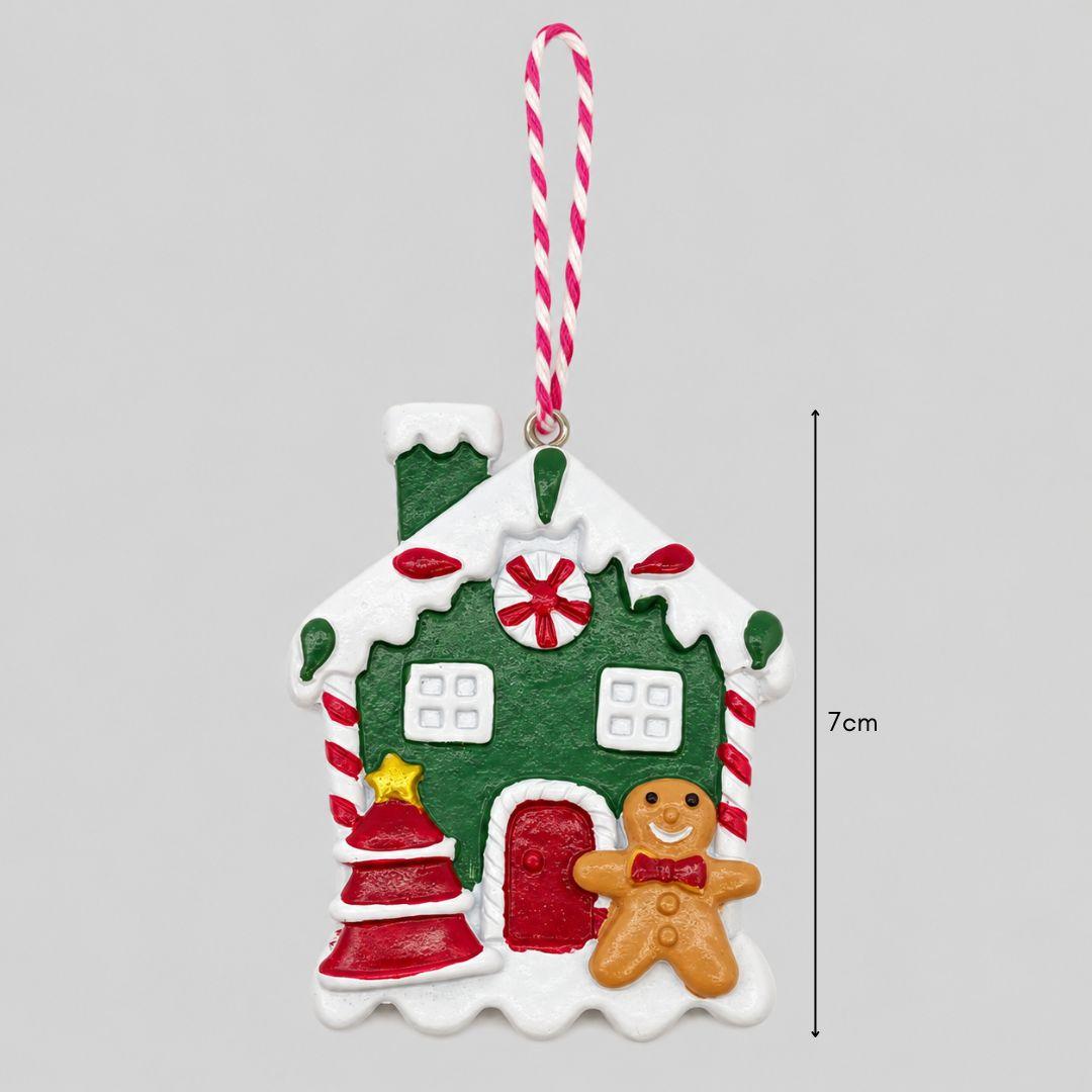 Little Joy red and green gingerbread house resin Christmas ornaments featuring snowy rooftops, candy cane details and miniature gingerbread characters on a Christmas tree.