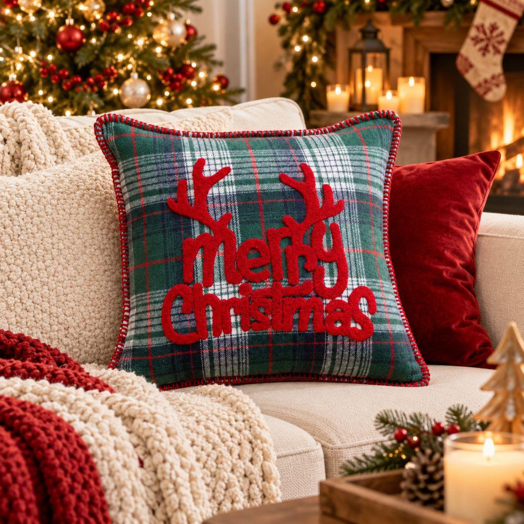 Green plaid Christmas cushion cover with raised red Merry Christmas lettering, reindeer antlers and stitched edging.
