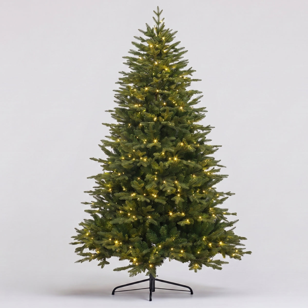 Realistic full-length view of the Natale Fraser Fir Pre-Lit LED Christmas Tree with dark-green, natural-looking needles on a sturdy base, a premium, low-maintenance artificial Christmas tree Singapore.