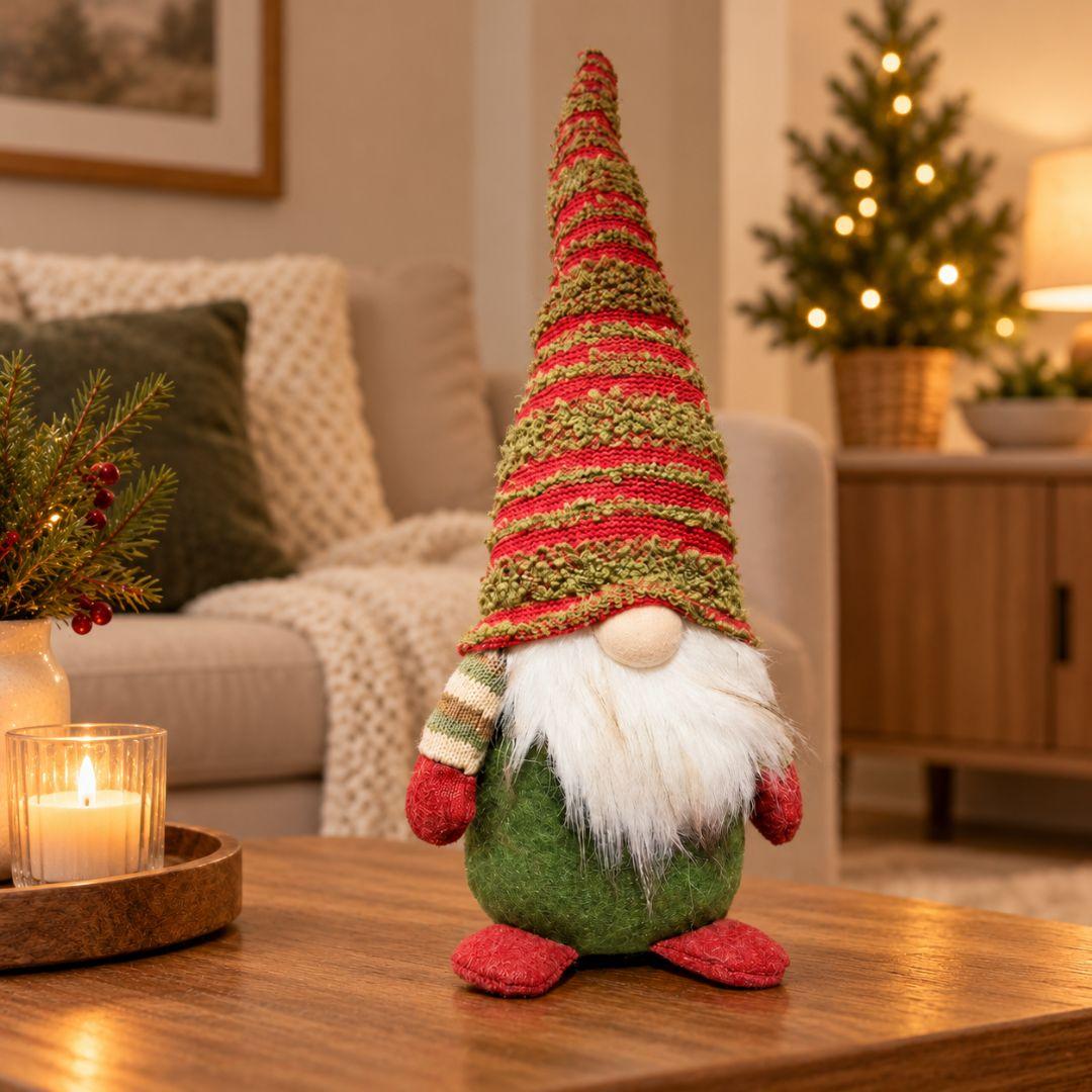 Nicholas woodland Christmas gnome with tall red and green knitted hat displayed on a wooden coffee table in a cosy living room