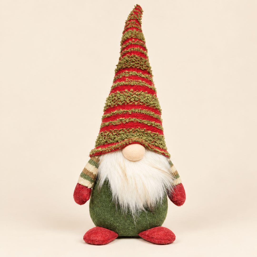 Nicholas woodland Christmas gnome with tall red and green knitted hat displayed on a wooden coffee table in a cosy living room
