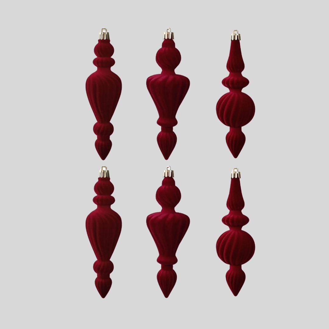 Ralph 16cm burgundy red velvet Christmas finial ornaments with sculpted ribbed textures and gold caps hanging on a warm-lit artificial Christmas tree.