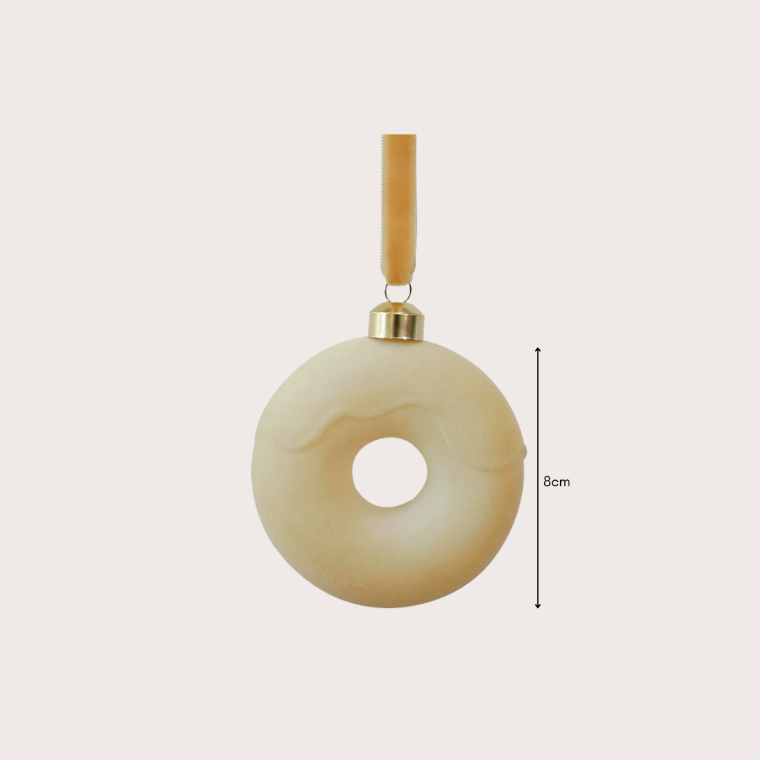 Ralph Heritage 8cm red and ivory velvet Christmas baubles with sculpted geometric patterns hanging on a warm-lit Christmas tree.