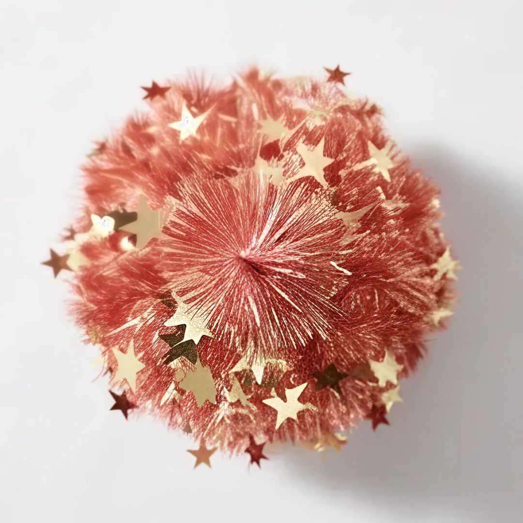Detailed close-up of the shimmering red tinsel foliage and integrated reflective foil accents on the Reinox Collapsible Christmas Tree, highlighting a premium festive finish that outshines standard pop-up options from Tidings