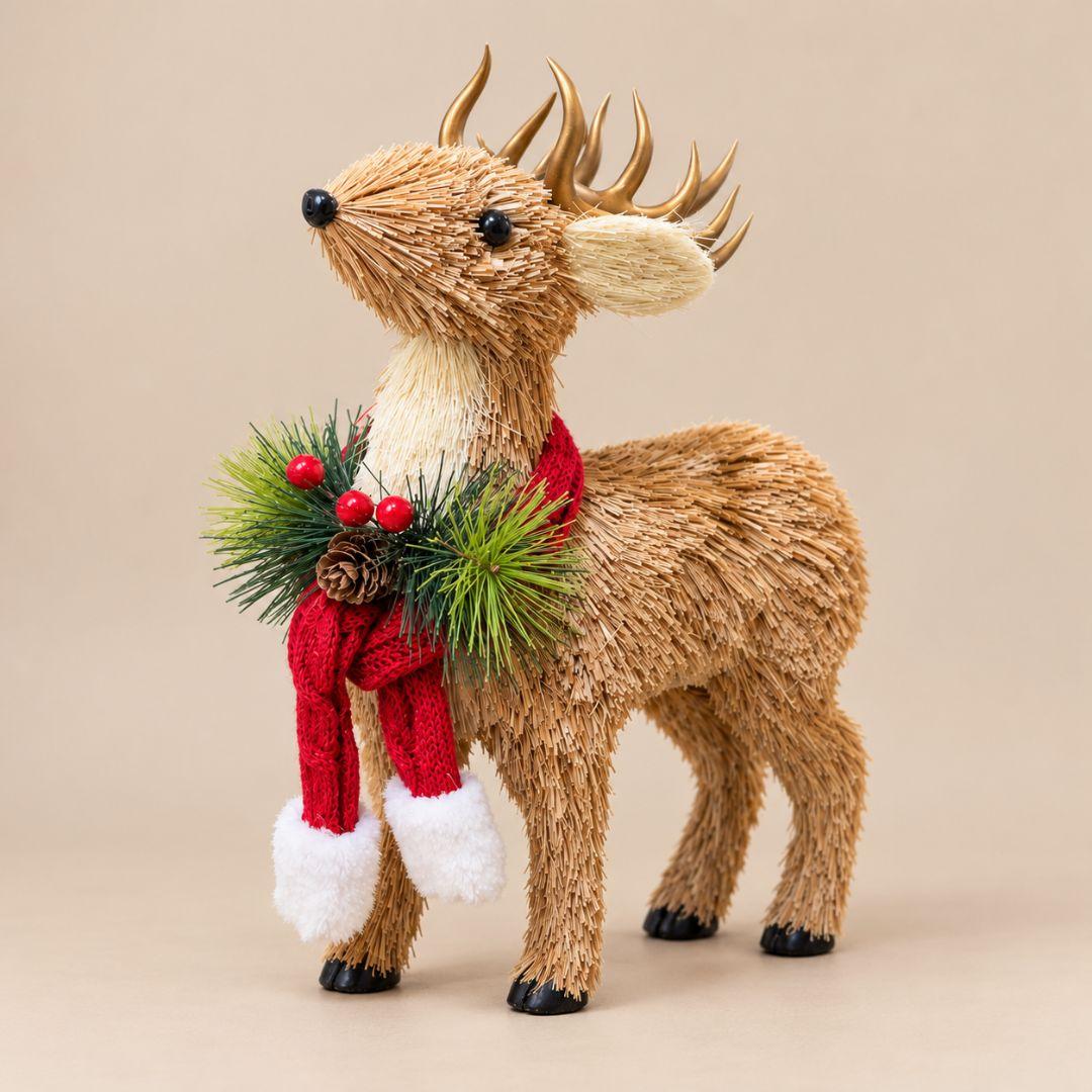 Rustic Christmas reindeer decoration with natural straw-like texture, gold antlers, red knitted scarf, pinecones and berries on a wooden console table.