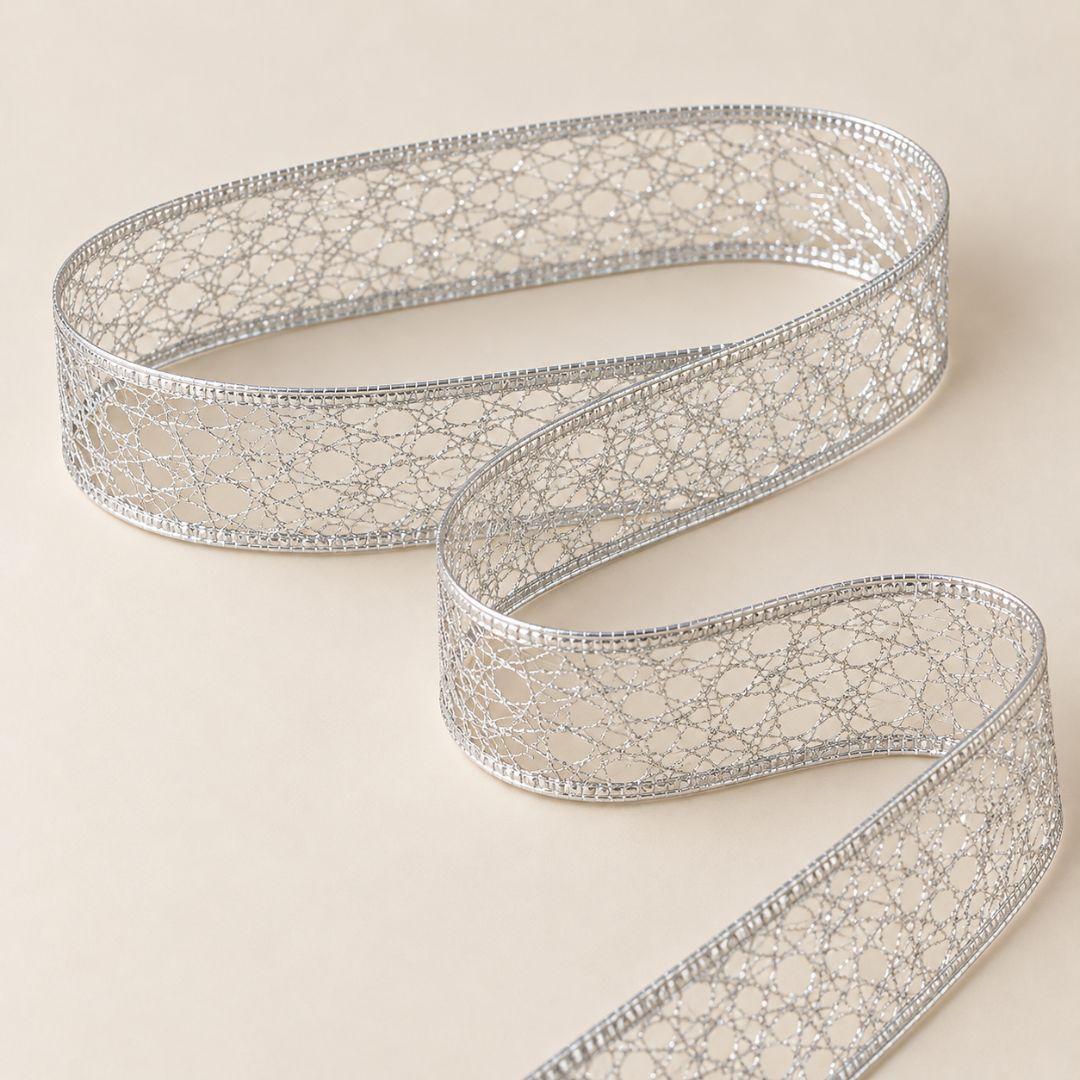 Silver metallic mesh Christmas ribbon with shimmering glitter accents, intricate open-weave design and wired edges, 5.5cm wide and 10m long.