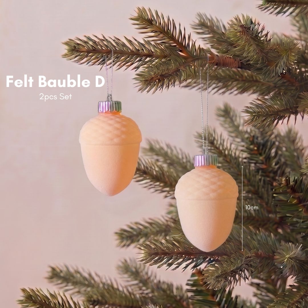 Close-up of a premium soft peach velvet Christmas bauble featuring a smooth, non-glitter finish for elegant Christmas tree styling in Singapore