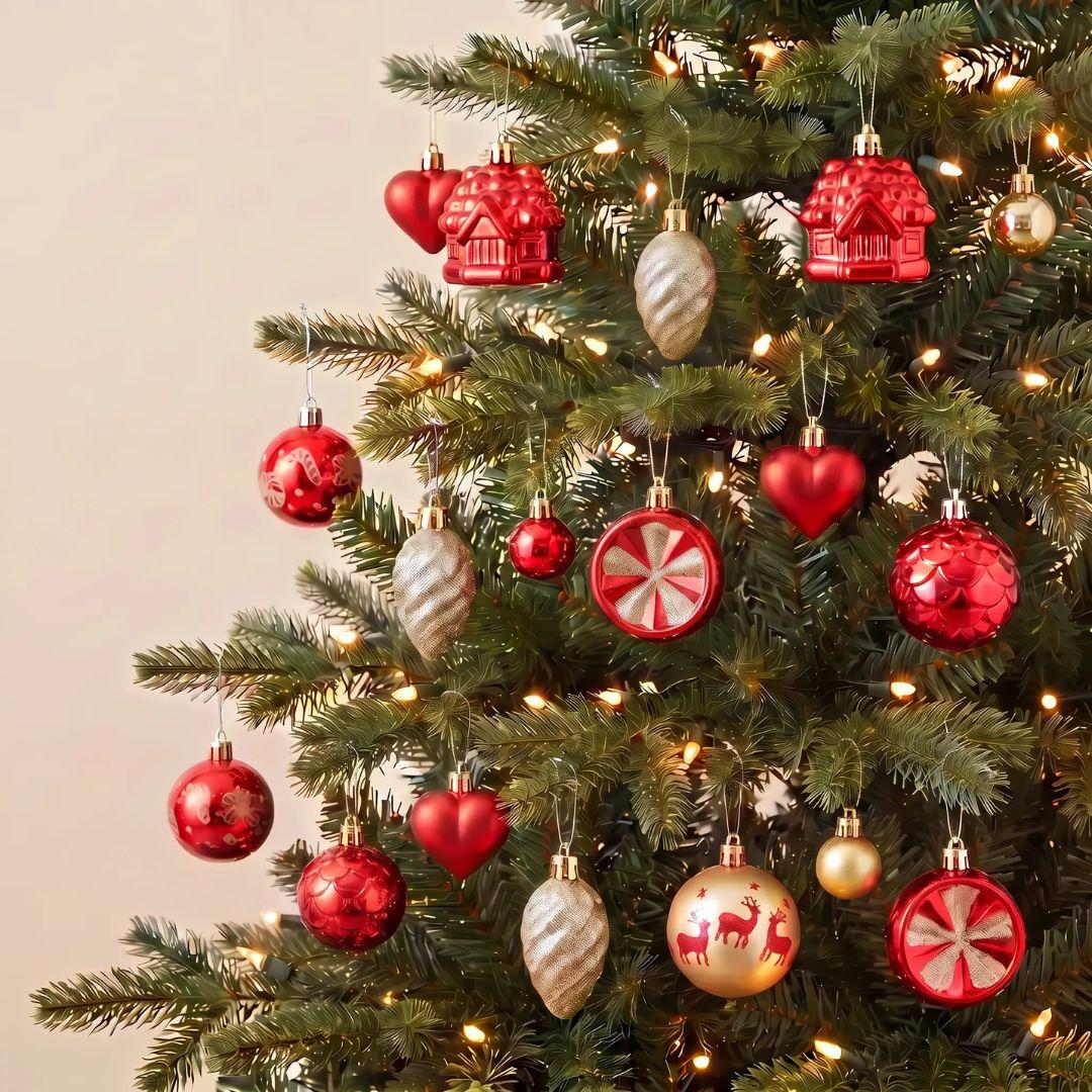 Red and Gold ornaments, including heart baubles, candy canes, house ornaments, and striped pinecones, with warm white string lights against a plain beige background.