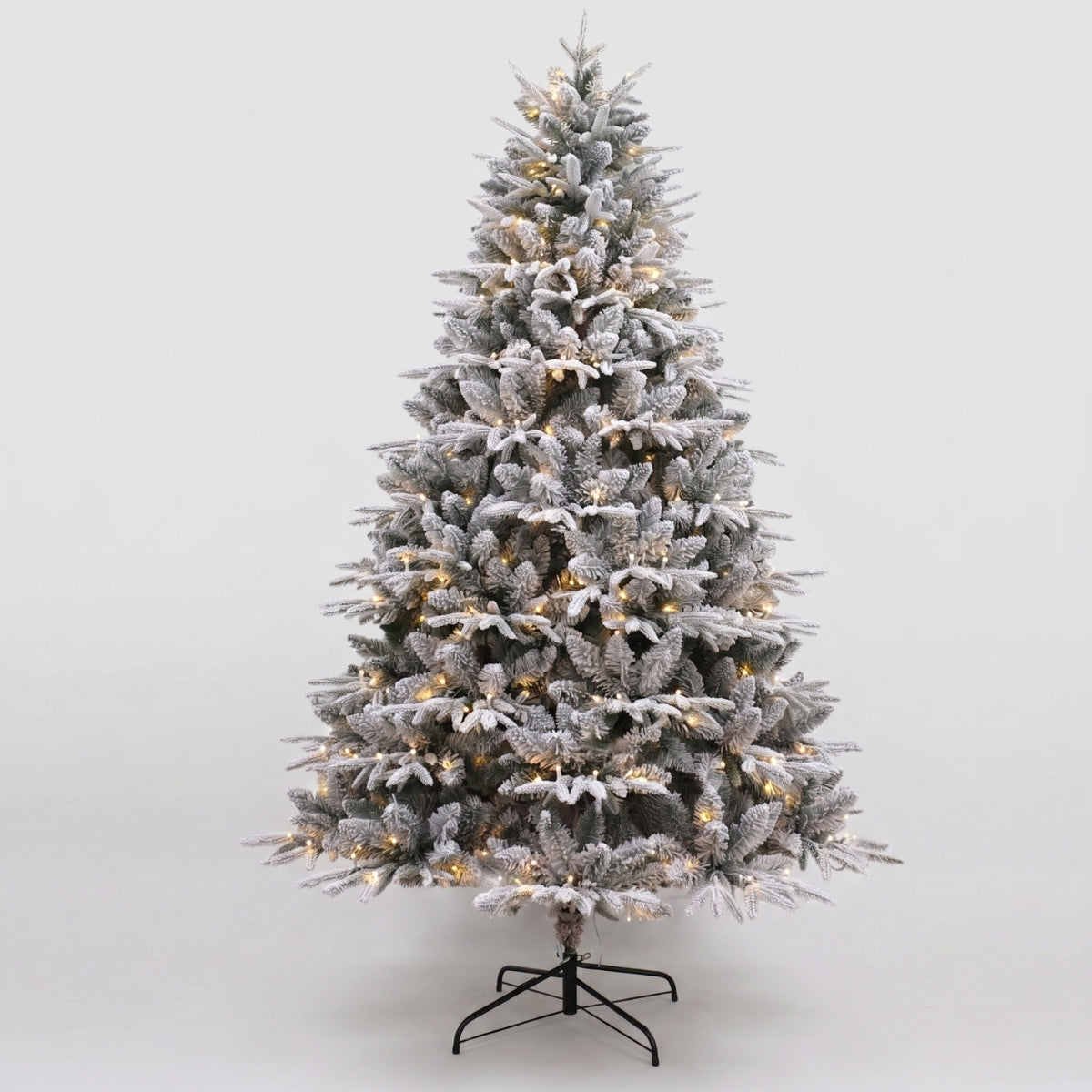A stunning pre-lit, heavily flocked Christmas tree, a centerpiece for a festive Christmas Tree in Singapore.