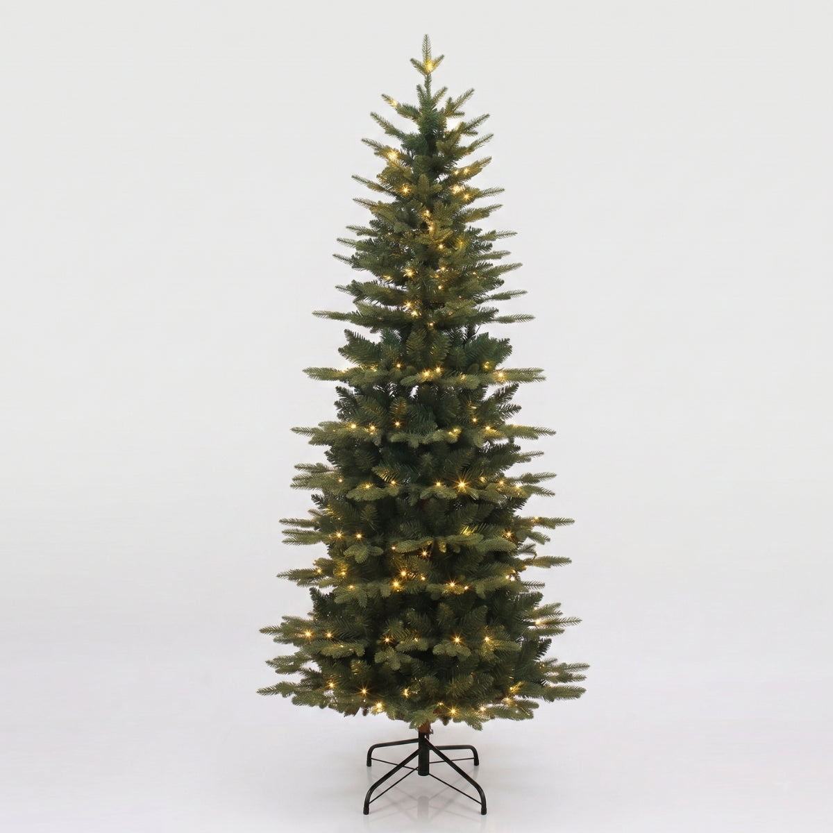 A full, pre-lit artificial Christmas tree with many warm white lights, space saving best for small spaces hdb homes Singapore