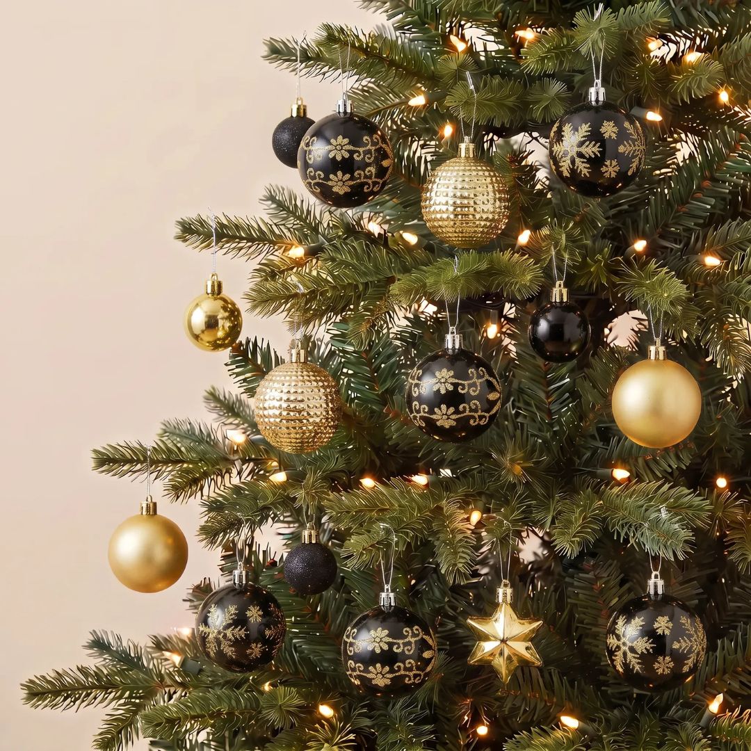 A boxed set of 44pcs black and gold plastic Christmas baubles featuring stunning glossy and glitter finishes.