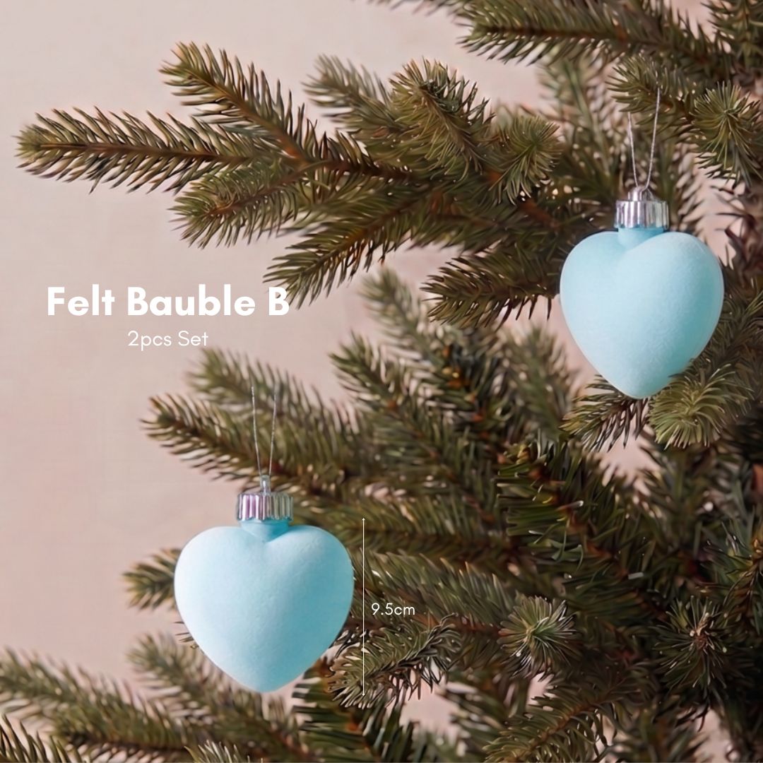 Statement 9.5cm blue velvet Christmas ornaments hanging on a modern artificial Christmas tree, featuring the best Christmas decorations to buy in Singapore