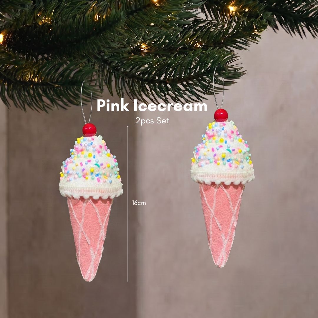 Close-up of a sweet pastel pink ice cream cone Christmas tree ornament hanging delicately on dark pine branches.