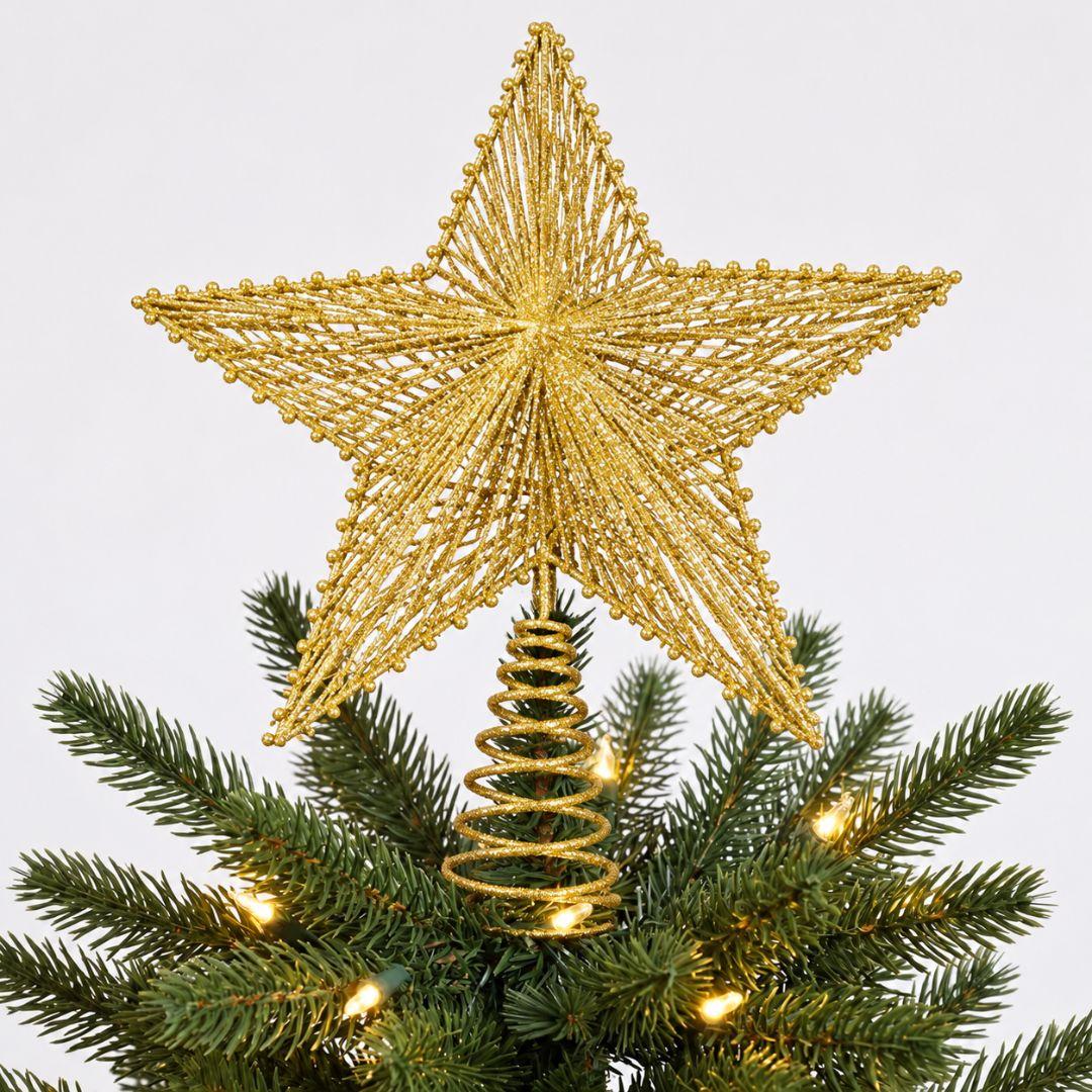 Gold glitter star topper displayed on a green artificial Christmas tree with warm white lights