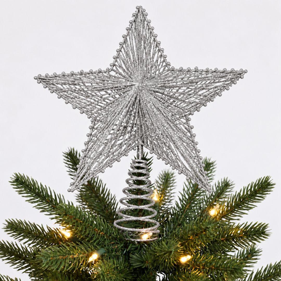 Silver glitter star tree topper on an artificial Christmas tree with warm white lights