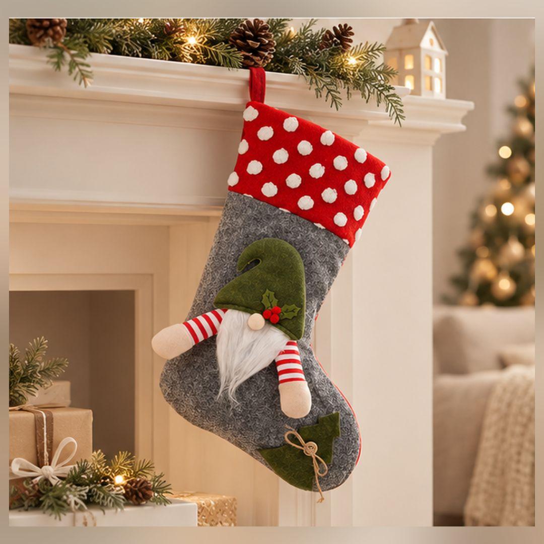 Grey Christmas hanging stocking with red polka dot cuff, plush green-hatted gnome, long white beard and decorative Christmas accents.