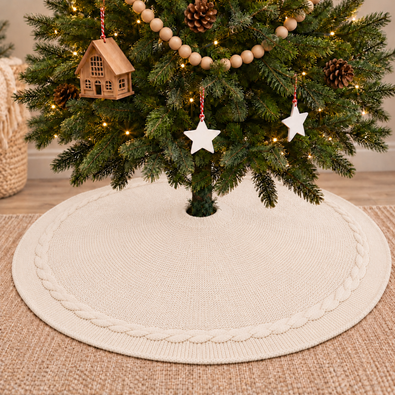 Cream knitted Christmas tree skirt covering tree stand