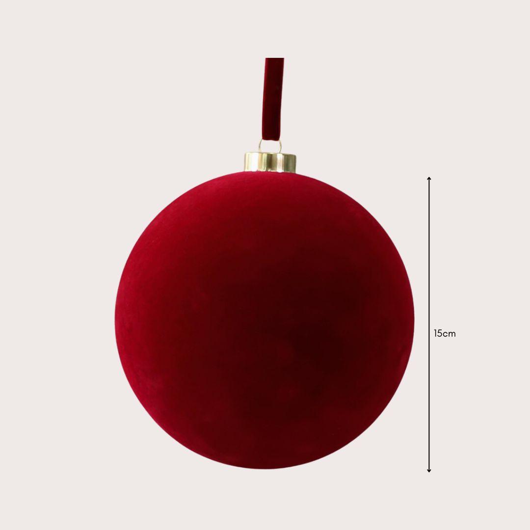 Large 15cm red and ivory velvet Christmas baubles hanging on a warm-lit artificial Christmas tree, featuring smooth and ribbed textures.