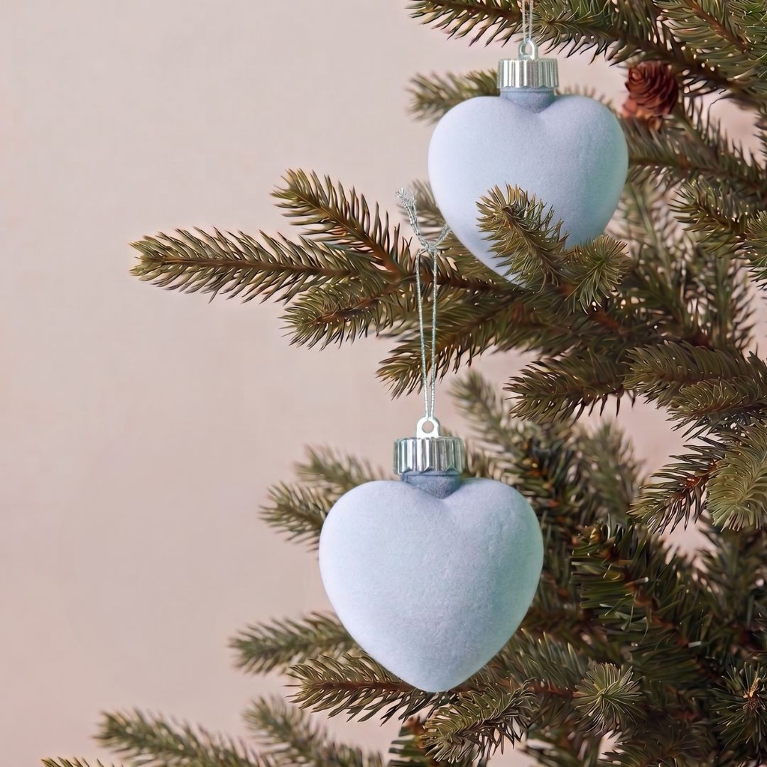 Statement 9.5cm light blue velvet Christmas ornaments hanging on a modern artificial Christmas tree, featuring the best Christmas decorations to buy in Singapore