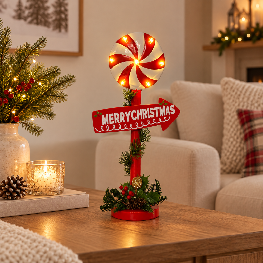Lolli Display LED Christmas Light Stand with glowing red and white peppermint swirl, Merry Christmas sign and festive greenery on beige background
