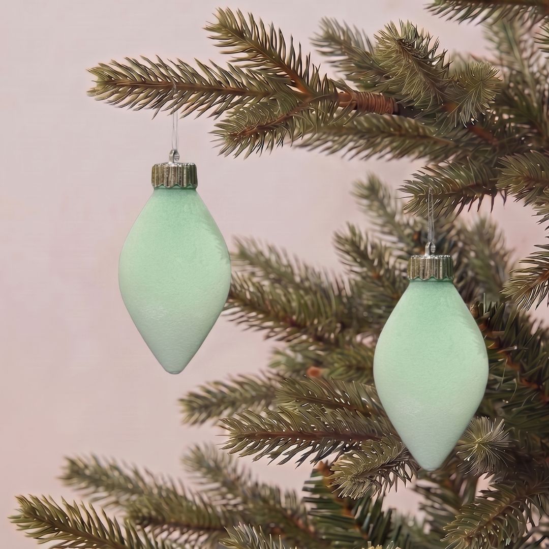 Beautifully decorated artificial Christmas tree featuring mint green velvet hanging ornaments and premium festive decorations by Speckled Space