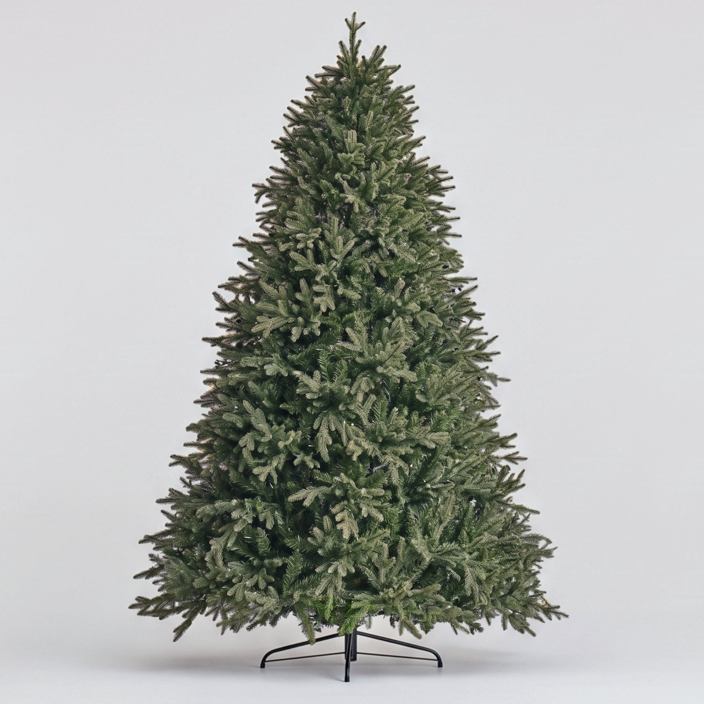 A grand Natale Fraser Fir Pre-Lit LED Christmas Tree fully decorated in a warm, festive Singapore home, showcasing a classic look