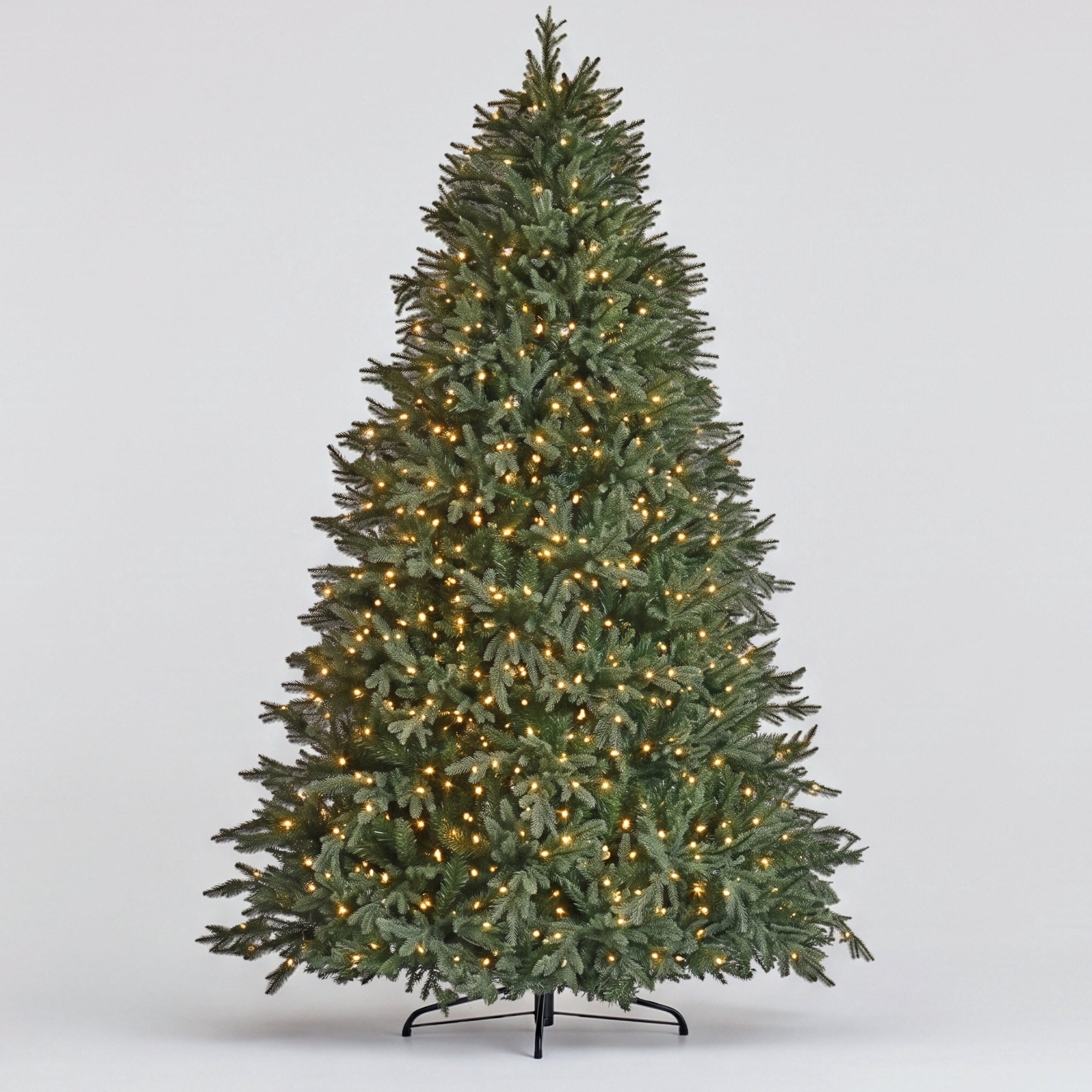 Realistic full-length view of the Natale Fraser Fir Pre-Lit LED Christmas Tree with dark-green, natural-looking needles on a sturdy base, a premium, low-maintenance artificial Christmas tree Singapore.
