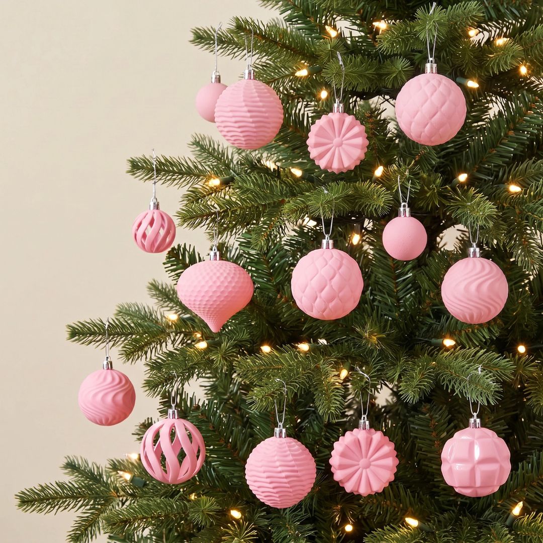 A beautifully styled Christmas tree in a Singapore home decorated with elegant velvet pink baubles and festive ornaments.