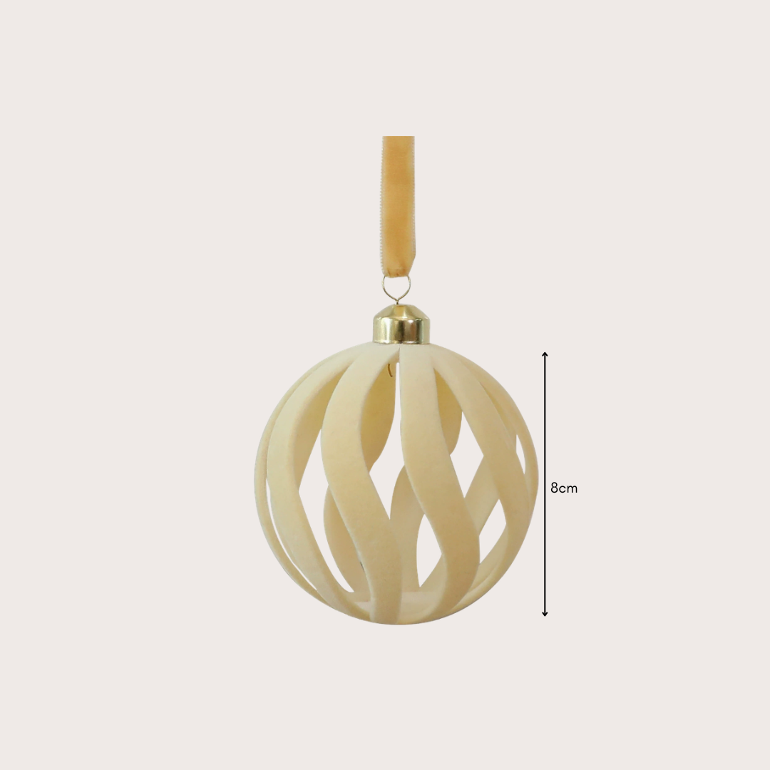 Ralph Heritage 8cm red and ivory velvet Christmas baubles with sculpted geometric patterns hanging on a warm-lit Christmas tree.