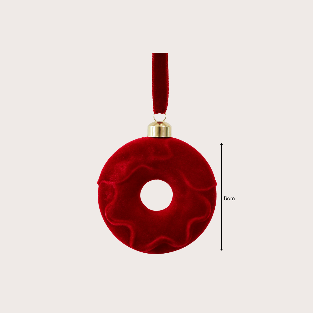 Ralph Heritage 8cm red and ivory velvet Christmas baubles with sculpted geometric patterns hanging on a warm-lit Christmas tree.