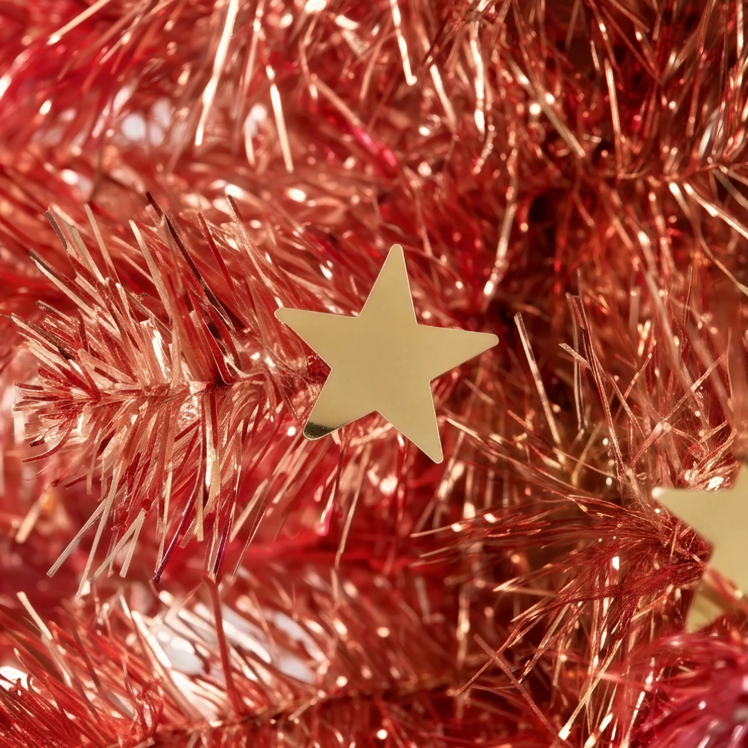 close-up of the shimmering red tinsel foliage and integrated reflective foil accents on the Reinox Collapsible Christmas Tree, highlighting a premium festive finish that outshines standard pop-up options from IKEA