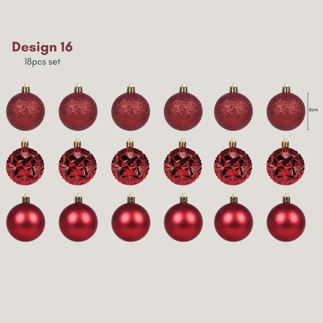 Yuletide Sparkle burgundy red 6cm Christmas baubles featuring glitter, satin and geometric starburst finishes hanging on a pre-lit artificial Christmas tree.