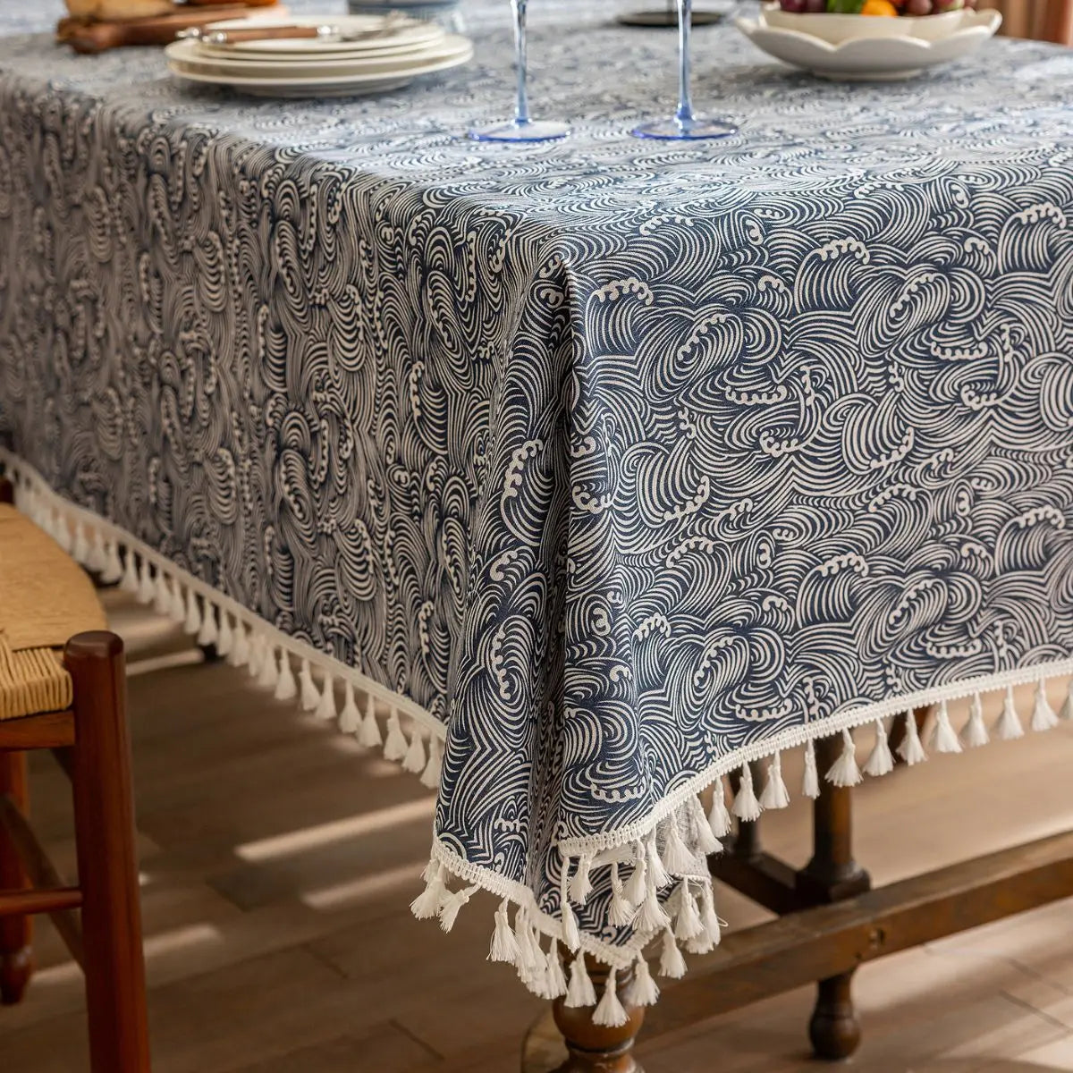 Blue Adelon table cloth and runner, featuring elegant fabric with intricate patterns for dining or decor.